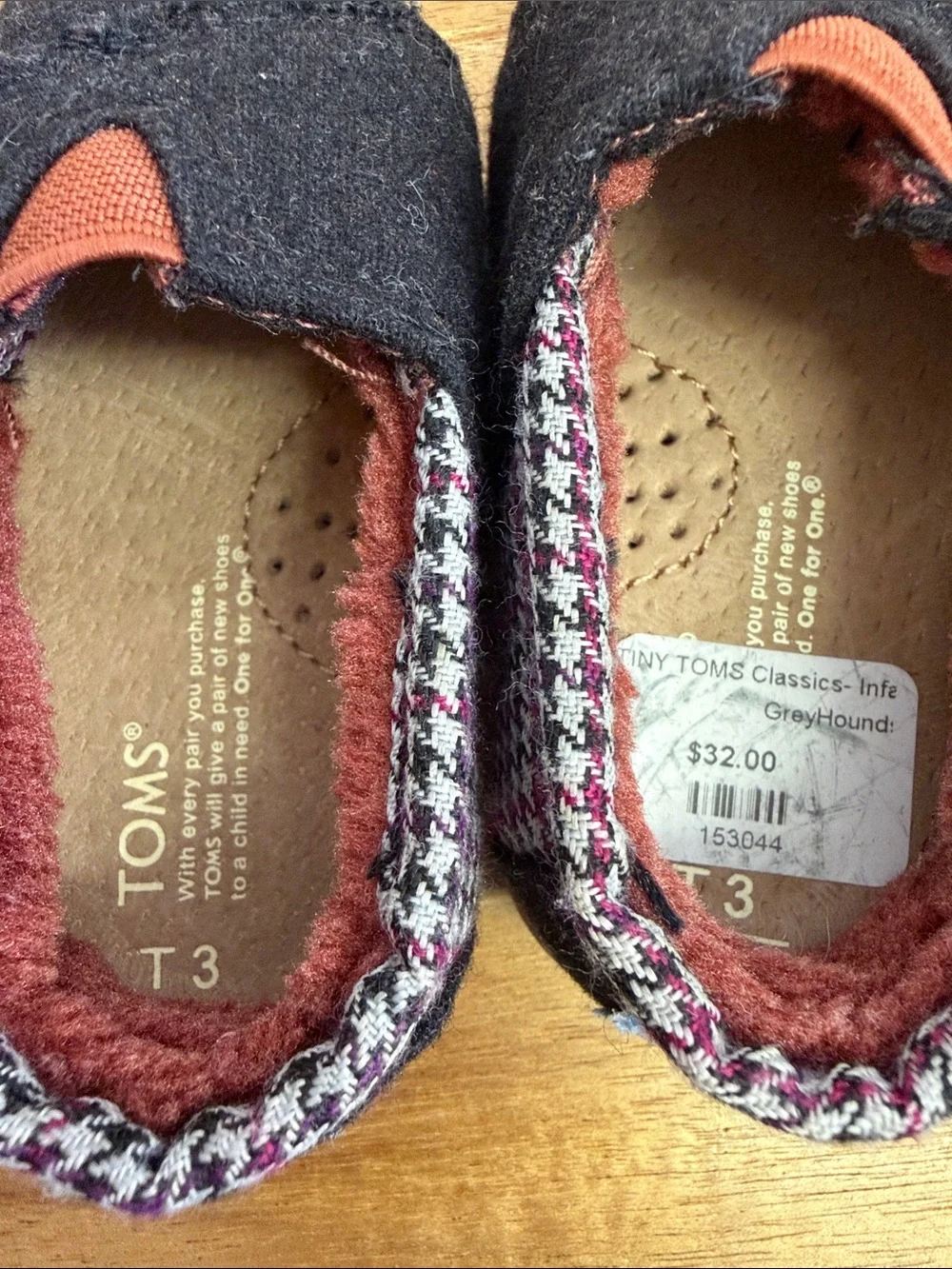 Toms Black Baby Slip-Ons with Rust Accent and Patterned Trim